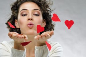 Woman Blowing Valentine Hearts