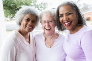 A diverse group of beautiful senior women enjoy time together outdoors.